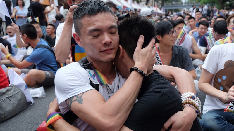 Same-sex activists embrace after learning Taiwan became the first place in Asia to legalise gay marriage (photo by Sam Yeh | AFP)
